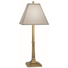 a gold lamp with a white shade on it