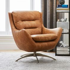 a brown leather chair sitting on top of a rug next to a book shelf filled with books