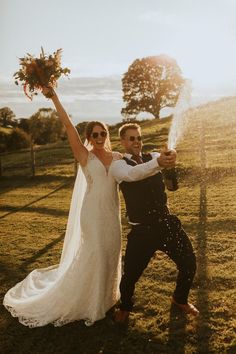 Bride in lace dress with long veil and neutral bouquet with groom doing champagne pop Orange Satin Bridesmaid Dresses, Wedding Dress Groom, Dark Suit, Pop Champagne, Bride Groom Photos, Orange Satin