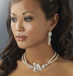 Freshwater Pearl Bridal Jewelry Set You'll love the unique design of this gorgeous bridal jewelry set. Lustrous freshwater pearls and brilliant crystal rhinestones combine in this beautifully detailed wedding jewelry set. The necklace features feminine floral detailing amidst sparkling crystals and a double strand of pearls. The 2" long earrings boast cascading pearls and crystals. This jewelry set will be the perfect finishing touch to your elegant wedding day look. Size: Necklace is 14 1/2" lo Bridal Jewelry Pearl Sets, Wedding Jewelry Set, Pearl Bridal Jewelry, Bridal Jewelry Set, Rhinestone Tiara, Vintage Inspired Jewelry, Pearl Bridal, Wedding Accessories Jewelry, Cz Jewelry