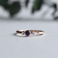 Genuine sapphire-adorned three stone ring. 14k Rose gold fully hallmarked 3mm blue Sapphire center stone. 1.75mm White Sapphires Approx 1.5mm band width FREE SHIPPING USA- All of our jewelry will arrive in custom packaging ready for gift giving. LEAD TIME: Made to order will take 10-14 days. Signature upon delivery, we unfortunately will not be able to reimburse or replace lost or stolen shipments. FOLLOW US ON: Instagram: @roseandchoc Facebook: /Roseandchoc Pinterest: @Roseandchoc Rose Gold Round Cut Sapphire Ring, Rose Gold Sapphire Ring With Round Cut, Rose Gold Sapphire Ring With Gemstone, Rose Gold Sapphire Birthstone Ring, 14k Rose Gold Filled Ring, London Topaz Ring, Ring Blue Sapphire, Trio Ring, Three Stone Ring