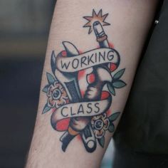 a man with a tattoo on his arm that reads working class and has scissors in it