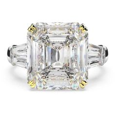 an emerald cut diamond ring with three baguets on the sides and two side stones