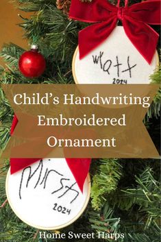 a christmas ornament hanging from a tree with the words child's handwriting on it