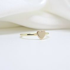 An all-gold and shiny heart will adorn your hand  🤍🤍 🤍 Details  The heart's size is 5,7mm. x  5,8mm. (approx.) and  thickness of heart is 1,00mm.(approx.) The band's thickness is 1,30mm.(approx.)  flat on the inside and slightly curved on the outside. 🤍 Materials All our items are made of 9 karats, 14 karats, or 18 karats solid gold upon request. We like to use yellow gold, white gold, and rose gold to please your color of choice. Use the drop-down material menu to find your favorite option. Gold Heart-shaped Stackable Rings For Valentine's Day, Gold Stackable Heart Ring For Valentine's Day, Rose Gold Stackable Heart Ring For Valentine's Day, Stackable Rose Gold Heart Ring For Valentine's Day, Gold Stackable Rings With Heart Charm In 14k Gold, Heart Shaped Yellow Gold Stackable Promise Rings, Heart-shaped 14k Gold Stackable Promise Rings, Stackable Rose Gold Heart Ring In 14k Gold, Stackable 14k Rose Gold Heart Ring