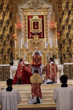 the priest is standing at the alter with other priests