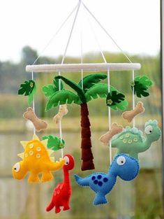 an image of a mobile that is made to look like dinosaurs and palm trees on the wind chime