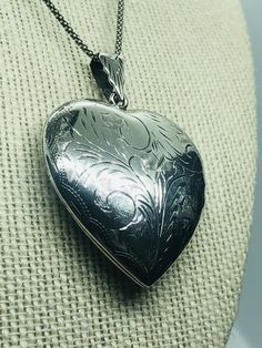 Vintage sterling silver heart pendant with a hand -engraved etched leafy scroll design on both sides of the pendant. Condition: Pre-owned -very good condition. Vintage Double Heart Engraved Necklace, Vintage Engraved Double Heart Necklace, Silver Etched Necklace For Valentine's Day, Valentine's Day Silver Etched Necklace, Antique Sterling Silver Etched Locket Necklace, Antique Etched Sterling Silver Locket Necklace, Antique Silver Engraved Heart Jewelry, Antique Heart-shaped Engraved Necklace, Victorian Silver Heart Pendant Locket Necklace