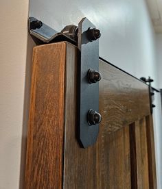 a close up of a wooden door with metal handles