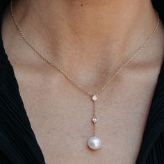 A statement piece for any stylish bride to be, this Pearl and Diamond Lariat Necklace is the perfect addition for your special day. The necklace features a two-inch gorgeous drop Pearl lariat adorned with two delicate bezel set pear shaped Diamonds. Wear with our matching earrings. White Fresh Water Pearl: 7 mm Natural Diamonds: 0.25ctw 14K White or Yellow Gold Drop: 2 Inches Length: 18 Inches Mavilo Exclusive Pearl And Diamond Pendant, Elegant Teardrop Pendant Drop Necklace, Luxury Pear-shaped Drop Necklace For Wedding, Elegant Drop Necklace With Pearl Chain, Luxury Pear Drop Necklace, Luxury Teardrop Pendant Drop Necklace For Wedding, Elegant Teardrop Drop Necklace For Anniversary, Luxury Teardrop Pendant Necklace For Wedding, Elegant Rose Gold Teardrop Pendant Drop Necklace