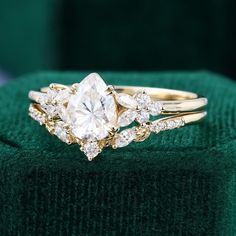 a close up of a diamond ring on a green cloth