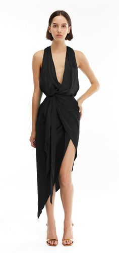 Elevate your look with this feminine dress, in aclassic black. This captivating dress features a draped bodice and an asymmetric wrap design that ties at the waist, enhancing your silhouette with elegance. 
Midi length
Asymmetric hem
Wrap design
Draped bodice
Black Black Asymmetrical Pre-draped Maxi Dress, Black Pre-draped Asymmetrical Dress, Elegant Wrap Dress With Asymmetrical Hem For Date Night, Chic Asymmetrical Wrap Dress For Party, Chic Sleeveless Wrap Dress For Night Out, Elegant Asymmetrical Wrap Dress For Evening, Elegant Asymmetrical Evening Wrap Dress, Elegant Black Midi Dress With Surplice Neckline, Black Wrap Dress For Night Out