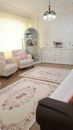 a living room filled with furniture and rugs