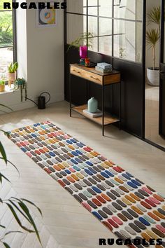 the rug is made from multicolored knits and has an interesting pattern on it