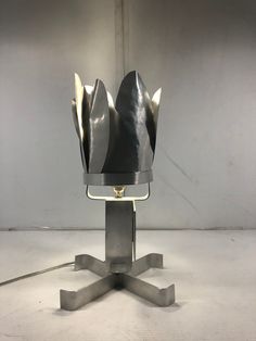 a table lamp that is on top of a metal stand with a light in the middle