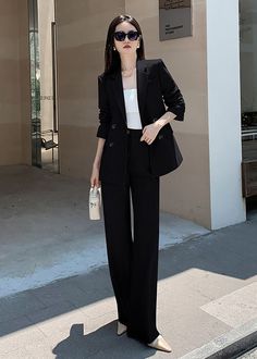 Elevate your wardrobe with our Estelle Double Breasted Blazer Wide Pants Suit. This two-piece set features a sophisticated and exclusive design with a double-breasted blazer and wide-leg pants. Perfect for any occasion, this black suit exudes elegance and taste. Blazer: Double Breasted closure Notched lapels Long sleeves Front flap pockets Pants Zip fly with button closure Side slant pockets Regular length - Polyester, spandex- Item #431910- Women's blazer & pants suit two-piece set SIZE INFO XS Chic Black Double Breasted Suit With Long Sleeve, Chic Black Double Breasted Suit, Black Double-breasted Evening Suit, Black Office Lady Pantsuit, Black Formal Office Sets, Black Formal Sets For Office, Black Office Lady Sets For Office Wear, Black Office Lady Sets, Elegant Black Double Breasted Suit For Office