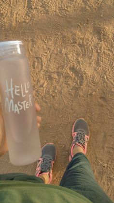 a person holding a water bottle with the words hello master written on it