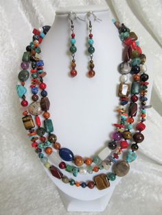 This multi gemstones necklace set is made so that each one is unique. Because all the beads vary in color, shape and size, and it is a random design, each necklace will be slightly different from the picture. I have tried to duplicate the earrings as closely as possible. This is a multi-colored celebration of gemstones from around the world. The necklace is 65 inches long and the earrings dangle 1 and 3/4 inches. I love collecting different shapes and sizes of gemstone beads and blending the col Multicolor Beaded Necklaces With Natural Stones, Multicolor Dangle Beaded Necklaces With Gemstone Beads, Colorful Natural Stones Jewelry For Jewelry Making, Multicolor Gemstone Beaded Necklaces With Dangle Shape, Multicolor Double Strand Crystal Necklace With Gemstone Beads, Bohemian Multicolor Beaded Gemstones, Unique Multicolor Gemstone Beads And Cabochons, Multicolor Agate Beads For Jewelry Making, Bohemian Multicolor Round Beaded Gemstones