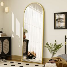 a large mirror sitting on top of a wooden floor next to a black and white rug