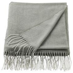 a gray blanket with fringes on it