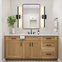 a bathroom with two sinks and a large mirror