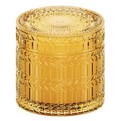 an ornately designed yellow glass jar with gold trimmings on the lid and sides