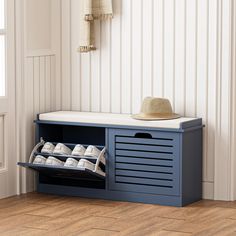 a shoe rack with two pairs of shoes in it and a hat hanging on the wall