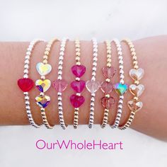 All of our bracelets are handmade in Hoboken, NJ, a little town which is near and dear to our hearts. This beautiful Swarovski heart bracelet is completely customizable - chose a single crystal heart or three. Also choose from 8 colors: red, fuchsia, rose, dusty lilac, mermaid, unicorn, clear, and silk. One inch of extra chain lets you adjust the bracelet to your preference. All items are hand-made in the USA in a smoke-free studio, and most importantly, they're made with OurWholeHeart❤︎ ------- Adjustable Heart Beads Crystal Bracelet Gift, Adjustable Crystal Bracelet With Heart Beads For Gift, Silver Beaded Crystal Bracelet For Valentine's Day, Valentine's Day Silver Beaded Crystal Bracelet, Adjustable Heart-shaped Crystal Bracelet Gift, Beaded Jewelry For Birthday On Valentine's Day, Beaded Jewelry For Birthday And Valentine's Day, Valentine's Day Birthday Beaded Jewelry, Gift Crystal Bracelet With Heart Charm And Round Beads