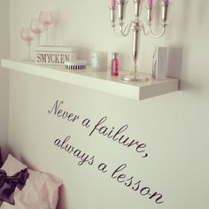 there is a sign that says never a failure always a lesson on the wall above it