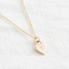 A simple but sweet symbol - this classic heart pendant is bead set with a tiny stone, or left plain. It sits close to the heart, and the back is just waiting to be engraved. Product details: Materials: Solid 14k Gold Pendant and Chain, or Sterling Silver Chain: 18 inches Measures: pendant is 1/2 inches by 3/8 inches Classic Heart-shaped Birthstone Necklace, Delicate Heart Charm Necklace With Round Pendant, Classic Heart Pendant Necklace With Birthstone, Everyday Double Heart 14k Gold Charm Necklace, 14k Gold Heart Charm Necklace For Wedding, Minimalist 14k Gold Necklace With Heart Charm, Everyday 14k Gold Double Heart Charm Necklace, Minimalist Heart-shaped Diamond Necklace, Minimalist Heart Shaped Diamond Necklace