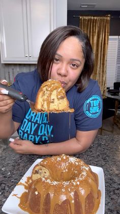 a woman eating a giant bundt cake on top of a white plate