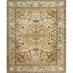 a rug with an ornate design on the center and sides, in beige tones that are hand - knotted together