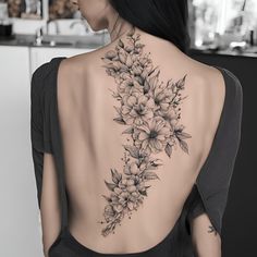 the back of a woman's neck with flowers on it