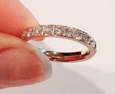 This is a gorgeous rose gold cubic zirconia band. 3 mm wide and super shiny. This band is 14 kt rose gold over stainless steel. Shines with a brillant fire. This ring is completely hypoallergenic, wear all day everyday. Swim, shower, very comfortable. Perfect to wear alone or as a spacer ring with any of my name rings. I guarantee customer satisfaction, and feel free to ask any questions. Classic Rose Gold Cubic Zirconia Stackable Rings, Rose Gold Stackable Rings With Diamond Accents, Round Cut, Rose Gold Eternity Band With Brilliant Cut Cubic Zirconia, Rose Gold Stackable Rings With Brilliant Cut, Rose Gold Cubic Zirconia Diamond Ring With Round Band, Rose Gold Half Eternity Round Diamond Ring, Rose Gold Round Half Eternity Diamond Ring, Stackable Diamond Rose Gold Eternity Band, Stackable Rose Gold Cubic Zirconia Diamond Ring