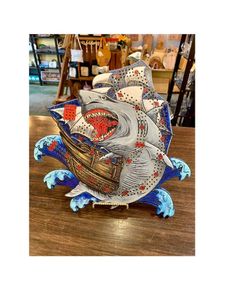 a paper boat is sitting on top of a table