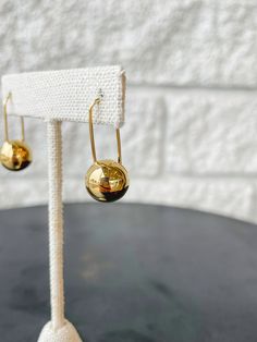 The metal spheres and mobile-inspired design create a contemporary and weightless variation of the classic drop earring. Finished in luxurious high-polish gold. Modern Metal Drop Hoop Earrings, Minimalist Metal Earrings With Shiny Finish, Modern Gold-plated Drop Hoop Earrings, Modern Gold Plated Drop Hoop Earrings, Modern Gold Hoop Earrings For Evening, Modern Everyday Elegance Earrings, Modern Linear Drop Earrings For Formal Occasions, Modern Gold Teardrop Linear Earrings, Modern Teardrop Yellow Gold Linear Earrings