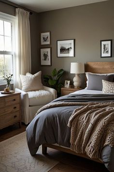 a bedroom with a bed, chair and pictures on the wall