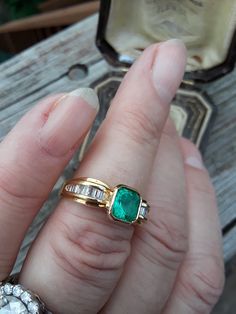 Beautiful 18k Yellow Gold, Approximately 1ct Cushion Cut Colombian Emerald, Diamond Baguette ring.. all sales are final. Weight is 5.5 Grams. Size 7 3/4.. Very Good Pre Owned Vintage Condition.. Ring Guard is NOT INCLUDED, just to show some ideas.. some pics ENLARGED to see details. Antique Box for Display only. Timeless Baguette Cut Emerald Ring For Wedding, Timeless Baguette Cut Emerald Wedding Ring, Formal 14k Gold Baguette Cut Emerald Ring, Timeless Baguette Cut Emerald Ring For Anniversary, Formal Baguette Cut Emerald Ring In 14k Gold, Emerald Ring With Baguette Diamonds In Fine Jewelry Style, Emerald Ring With Baguette Diamonds Fine Jewelry, Yellow Gold Baguette Cut Emerald Ring For Formal Occasions, Elegant Emerald Ring With Baguette Diamonds For Formal Occasions