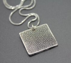 "These handmade sterling silver necklace pendants feature your actual fingerprint. They are lovingly handmade from the finest materials making them the perfect wedding, grievance, or Christmas gift! Numerous shapes, styles, and sizes are available in my shop and we love custom orders! * Material: All pendants are handmade from solid sterling silver. Chains are also sterling silver. * Dimensions: Square pendant measures approximately 20mm across. * Finish: You choose! Shiny, filled, or antiqued. Sterling Silver Stamped Necklace With Rectangular Pendant, Hand Stamped Rectangular Pendant Necklace In Sterling Silver, Silver Necklace With Square Pendant For Keepsake, Silver Rectangular Pendant Necklace For Anniversary, Silver Square Pendant Necklace For Keepsake, Sterling Silver Etched Necklaces For Wedding, Sterling Silver Rectangular Pendant For Anniversary, Sterling Silver Hand Stamped Rectangular Pendant Jewelry, Stamped Sterling Silver Necklace For Wedding