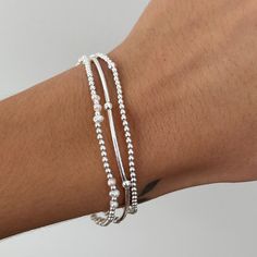 Elevate your look with this beautiful Freshwater Pearl & Sterling Silver Stretch Bracelet! Made with genuine freshwater pearls and 925 sterling silver beads, it will add a touch of elegance to any outfit. The stretch design makes it easy to slip on and off, and it fits comfortably on most wrist sizes.  Experience the timeless beauty of pearls and sterling silver or gift it to someone you love. Perfect on its own or layer with other pieces from our collection.  The other bracelets pictured are not included, but are available on our website and in our Etsy store 💖 Details 925 Sterling Silver Pearls: 3-4 mm Heart: 11 nmm Diameter: approx 18 cm  Fits S/M wrists 💖 Online store: www.thejewellerytree.net 💕 Stay up-to-date with new designs & special offers  - FOLLOW ME   Socials: @myjewellerytr Silver Stackable Pearl Bracelet With Round Beads, Silver Stackable Pearl Bracelet Gift, Silver Bracelet Stack, Bracelet Pearl, Sterling Bracelets, Ball Bracelet, 2025 Vision, Freshwater Pearl Bracelet, Jewelry Tree