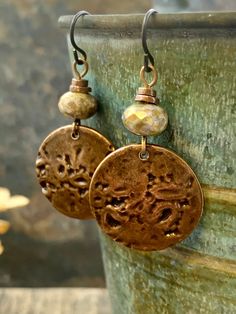 These are my handmade Copper Disc Earrings with earthy toned Czech glass beads. The copper metal discs are domed and have texture, with a very earthy tribal aesthetic, a bit Boho chic style. A great pair of everyday earrings! The ear-wires are hypoallergenic niobium wire, safer for sensitive ears. I create each piece of metal by hand, my jewelry is earthy, rustic, and organic with intentional artistic imperfections. No two pieces are exactly alike, creating truly one of a kind jewelry. ❤SIZE *7/ Bohemian Brown Round Earrings, Brown Bohemian Round Earrings, Bohemian Brown Beaded Nickel-free Earrings, Bohemian Brown Beaded Round Earrings, Nickel-free Brown Bohemian Earrings, Adjustable Earthy Dangle Earrings, Bohemian Bronze Earrings With Round Beads, Handmade Earthy Earrings For Festival, Brown Bohemian Earrings With Round Beads