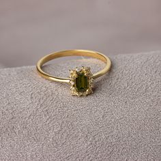 "With its shimmering pale green color, peridot stone is also known as the \"evening emerald\". It is a gemstone often associated with spirituality and expression. Our rectangular peridot stone ring surrounded by real diamonds will add elegance to your hands. It is a ring that you can use both on special occasions and in daily life. It is a beautiful and stylish product that you can gift to yourself and your loved ones. The color of those born in August is Peridot. Our necklace compatible with ou Peridot And Gold Ring, Vintage Green Rings, Engagement Rings Gold Colored Stone, Peridot And Diamond Engagement Rings, Virgo Engagement Ring, Diamond And Peridot Engagement Rings, Elegant Peridot Crystal Ring As A Gift, Elegant Peridot Crystal Ring Gift, Green Emerald Cut Crystal Birthstone Ring