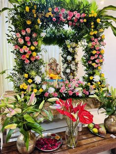 there are many flowers and plants in vases on the table next to each other