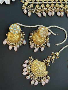 This lightweight and dainty set in thapa kundan or multani work is made of high quality gold plating and has gorgeous pink crystal drops that have an ombre finish. The colors are super unique and pastel so that they can go with any outfit whether its a saree or lehenga! and can be worn separately for a simple look. This lightweight and elegant necklace is perfect for any bridesmaid, bride, sangeet or any occasion or event as a gift for any occasion as any one who loves jewelry will love this sta Pink Chandbali Set With Mirror Work, Elegant Pink Kundan Jewelry Sets, Elegant Pink Kundan Sets, Pink Festive Tikka, Pink Bridal Sets For Festive Occasion Gift, Pink Bridal Sets For Festive Gift, Pink Bridal Sets For Festive Occasion, Elegant Pink Bridal Set With Stone Work, Festive Pink Bridal Sets As A Gift