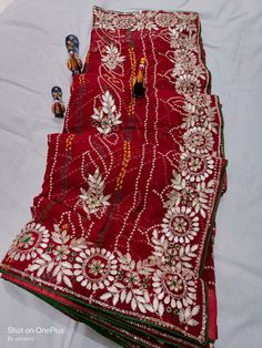 Red Chanderi Sharara With Mirror Work, Red Chinon Sharara With Cutdana, Red Chinon Sharara With Cutdana Detail, Traditional Red Pre-draped Saree For Festive Occasions, Red Traditional Wear With Mirror Work, Navratri Multicolor Pre-draped Saree With Gota Work, Red Chanderi Traditional Wear With Mirror Work, Red Georgette Choli With Cutdana, Traditional Red Sets With Mirror Work