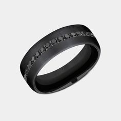 Introducing the Edison, a masterpiece of modern jewelry design that marries the sleek, enduring appeal of black titanium with the opulent brilliance of black diamonds. This 6.5mm comfort fit wedding band is a symphony of sophistication and strength, featuring a satin finish on black titanium that serves as the perfect backdrop for the twenty channel-set black diamonds. With a total carat weight of .40ct, these diamonds sparkle with a mysterious allure, making the Edison not just a ring, but a st Black Diamond Wedding Rings, Wedding Ring Diamond Band, Comfort Fit Wedding Band, Modern Jewellery Design, Men Rings, Black Diamond Ring, Black Diamonds, Channel Set, Mens Wedding Bands