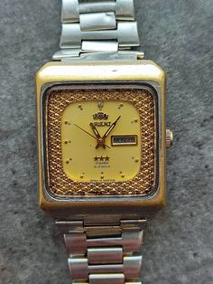 Japanese men's watch from the 1970s (possibly 1960s) Orient Crystal M 0S559F055, also called ICON, due to the shape of the case and style of execution. Automatic, waterproof, vintage Japanese automatic mechanical watch with original bracelet. The mechanism is fully working and serviced. The watch is in good vintage condition, the gold color on the bracelet has not been preserved. - Case dimensions   37 mm(1.5 in) x 30 mm(1.2 in) x 32 mm(1.3 in) with crown x 11 mm(0.4 in) - 21 jewels, mechanical movement, self-winding - caliber 0S559F055 - Day - Date The package will be shipped within two days and you will receive a tracking number immediately.  UPS Expedited Mail Services. Delivery time to USA and Europe is about 6-14 business days.                                                         T Retro Watch With Rectangular Dial For Anniversary, Retro Watches With Rectangular Dial For Anniversary, Retro Gold Watch With Date Display, Retro Analog Watch For Anniversary, Luxury Retro Watch Accessories With Automatic Movement, Vintage Watch With Analog Display And Rectangular Dial, Vintage Rectangular Watch With Metal Dial, Vintage Rectangular Analog Watch, Vintage Automatic Watches For Business