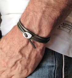 "Mens Grey flat leather cuff, leather wrap bracelet, silver adjustable glasp bracelet, for him, mens , urban wrap cuff, mens bracelets Welcome to my shop! ✈️ DHL EXPRESS SHIPPING AVAILABLE, 1-3 BUSINESS DAYS DELIVERY! ✔️ PLEASE MAKE SURE TO SELECT IT, RIGHT BEFORE YOUR PURCHASE! ❗️ ❗️ DON'T FORGET TO ADD YOUR CELL # AT THE \"NOTE TO SELLER\" SECTION IF YOU CHOOSE DHL! BY FILLING YOUR CELL NUMBER YOU EARN THE BENEFIT TO CHOOSE BETWEEN 6 DIFFERENT DELIVERY OPTIONS! INSTRUCTIONS WILL BE SENT TO YOU Men’s Leather Bracelet, Leather Silver Bracelet, Mens Sterling Silver Jewelry, Bracelet For Him, Minimal Bracelet, Mens Bracelets, Trending Bracelets, Grey Flats, Mens Bracelet Silver