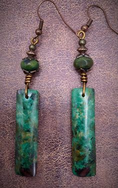 OMG I LOVE these beautiful stones! The colors are so amazing and vibrant.  A rectangular green  Chrysocolla stone is accentuated with a beautiful matching green jasper stone and hand wrapped wire. Antique copper bead caps and bead finishes the look. Unique and a must have for the boho jewelry lover! Bohemian Jade Gemstone Earrings, Handmade Spiritual Jade Earrings, Bohemian Jade Earrings, Nickel Free Bohemian Jade Earrings, Bohemian Jade Earrings With Ear Wire, Bohemian Nickel Free Jade Earrings, Bohemian Dangle Jade Jewelry, Bohemian Green Earrings With Natural Stones, Bohemian Jade Dangle Jewelry