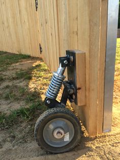 a wheel attached to the side of a wooden fence